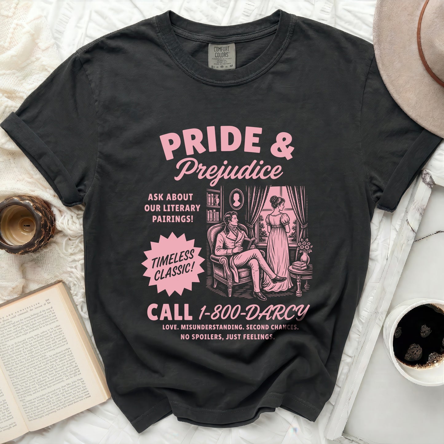 Black Comfort Colors t-shirt with pink Pride & Prejudice graphic and phone number.