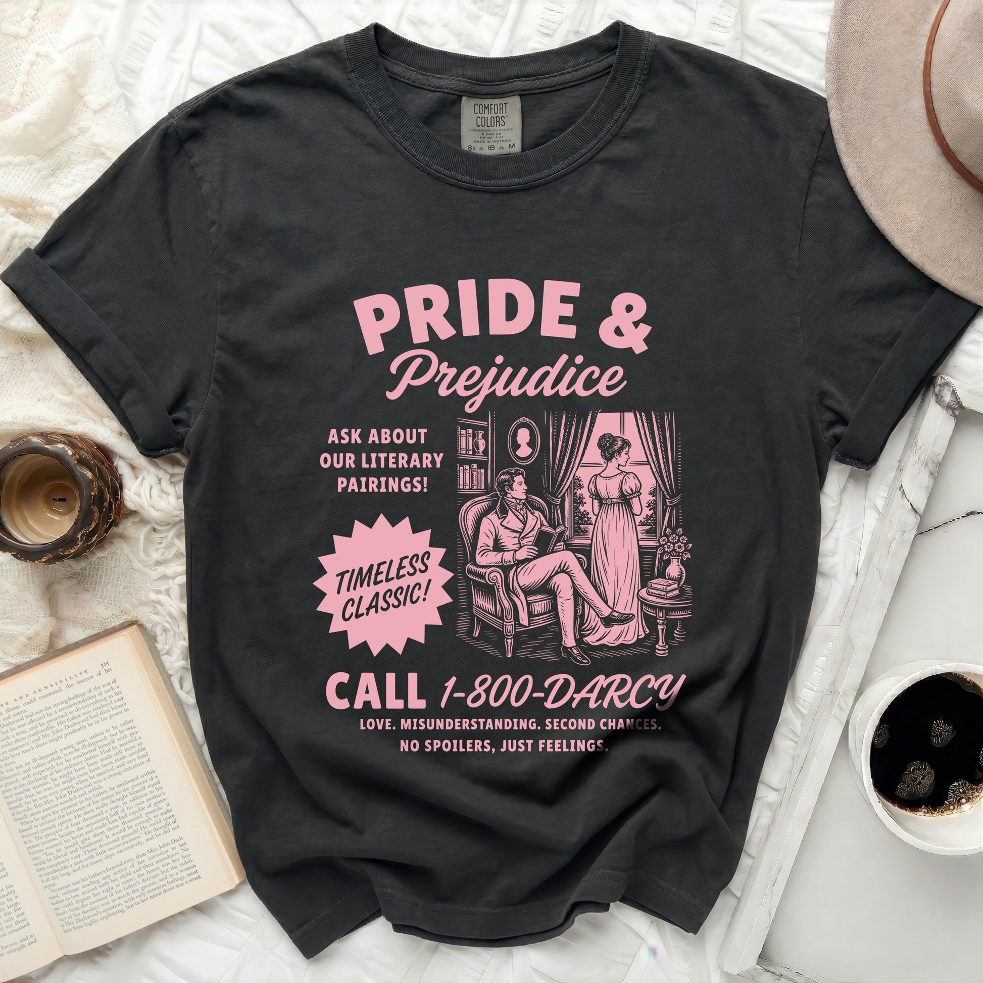 Black Comfort Colors t-shirt with pink Pride & Prejudice graphic and phone number.