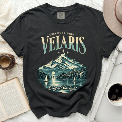 Black t-shirt with "Greetings from Velaris City of Starlight" graphic.
