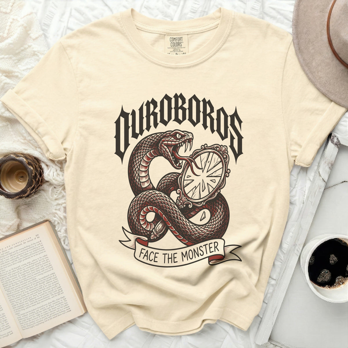 Cream t-shirt with a snake coiled around a broken mirror and text "Uroboros Face The Monster".