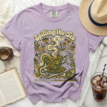 Purple t-shirt with "Spilling the Tea" and psychedelic floral design.