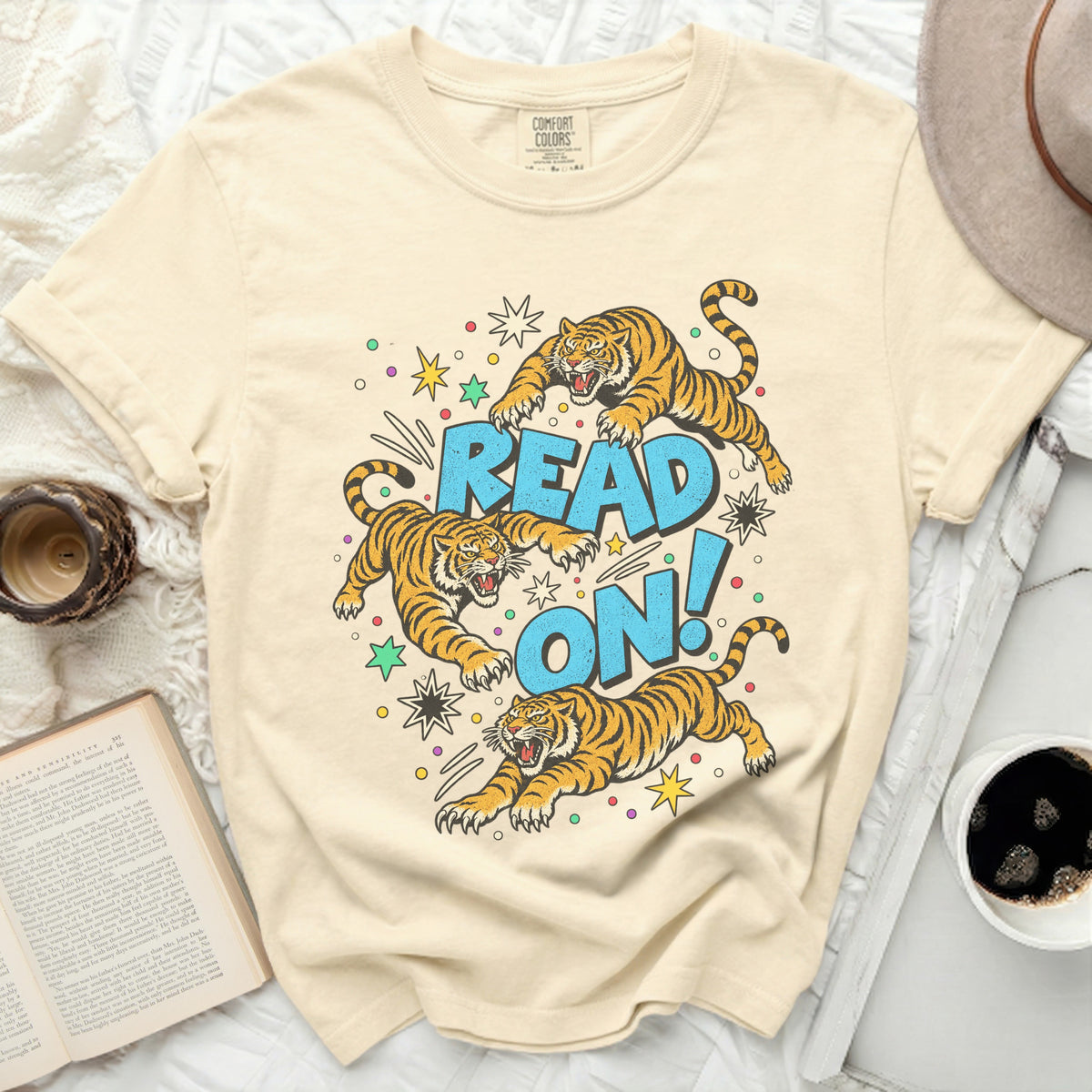 Cream t-shirt with cartoon tigers jumping around the text "READ ON!".