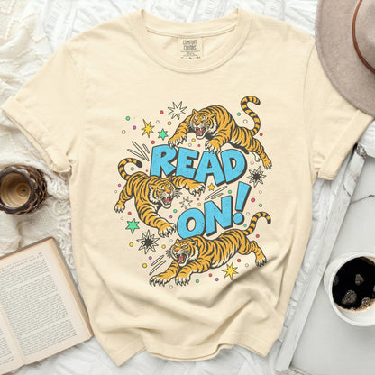 Cream t-shirt with cartoon tigers jumping around the text "READ ON!".