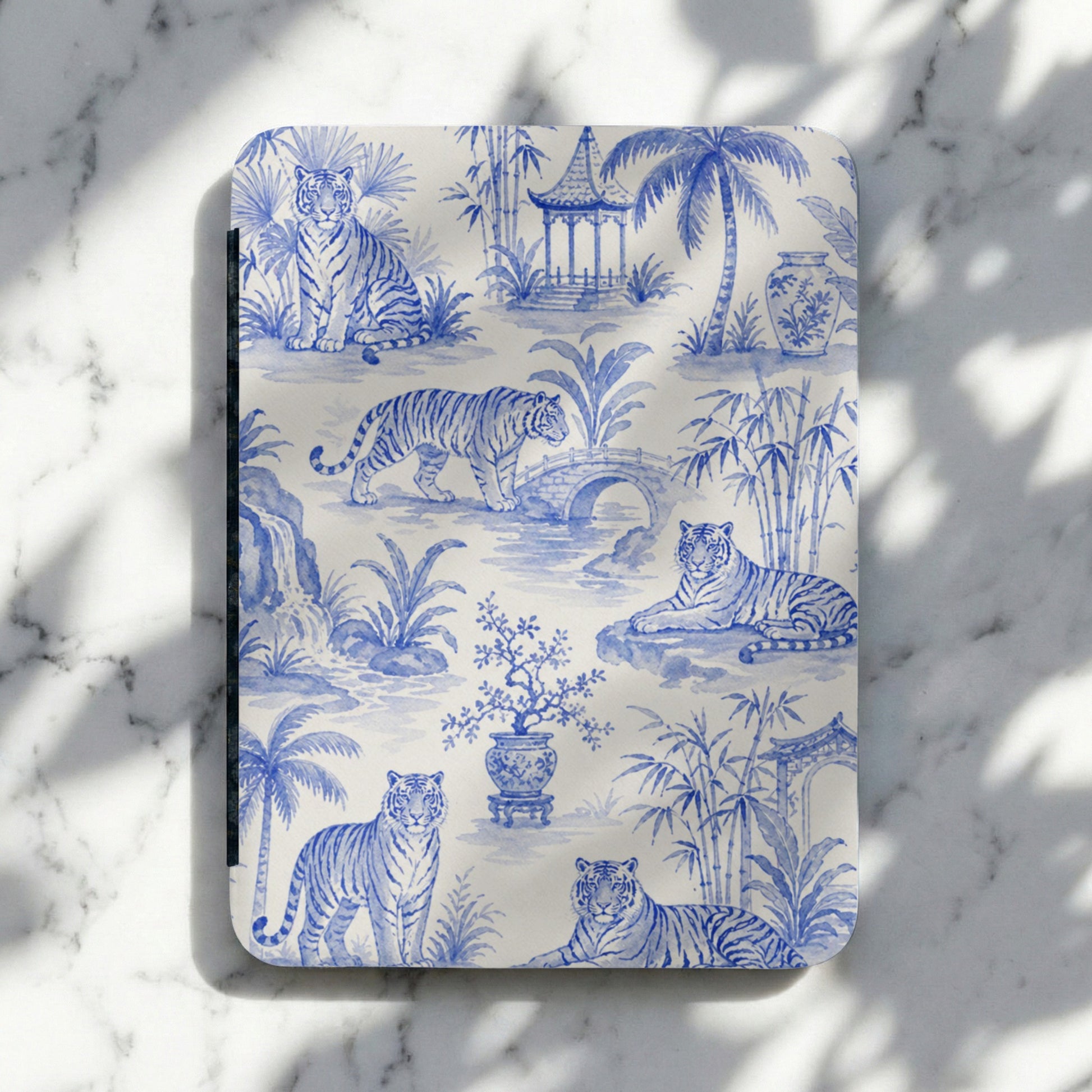 Blue and white toile pattern with tigers, bamboo, palm trees, and a pagoda.