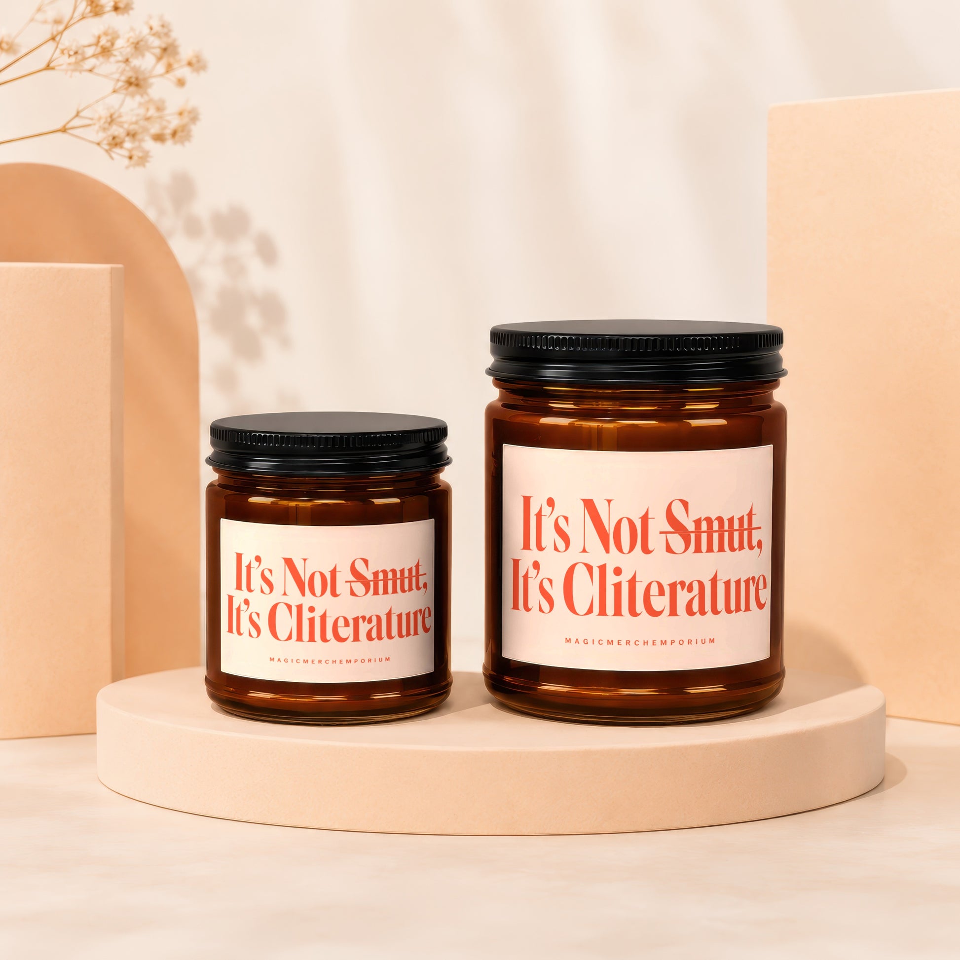 Two amber jars with black lids, one larger than the other, labeled "It's Not Smut, It's Cliterature."