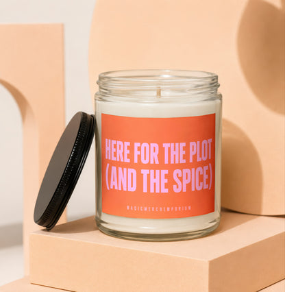 Candle with orange label reading "HERE FOR THE PLOT (AND THE SPICE)".
