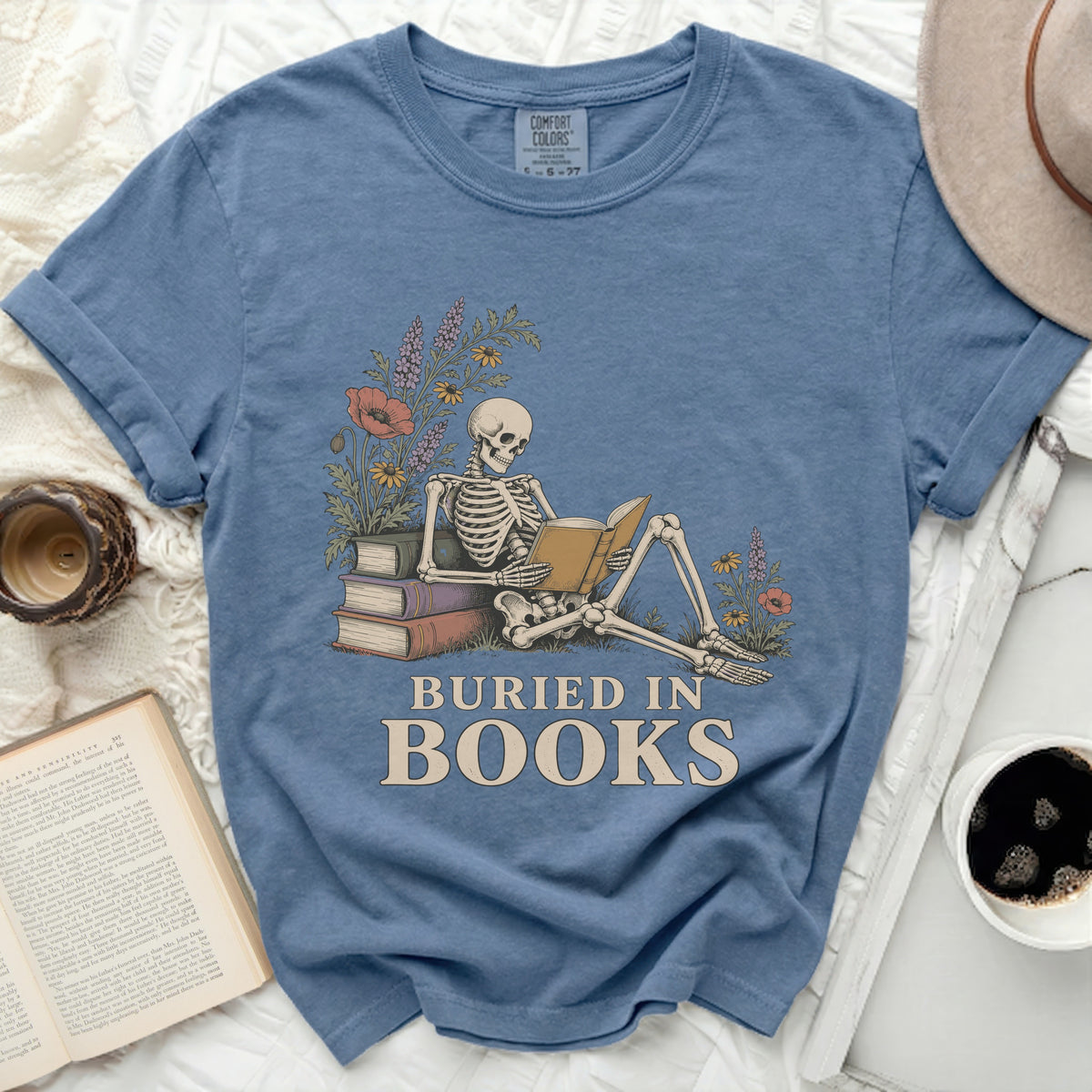 Skeleton reading book with flowers and "Buried in Books" text.