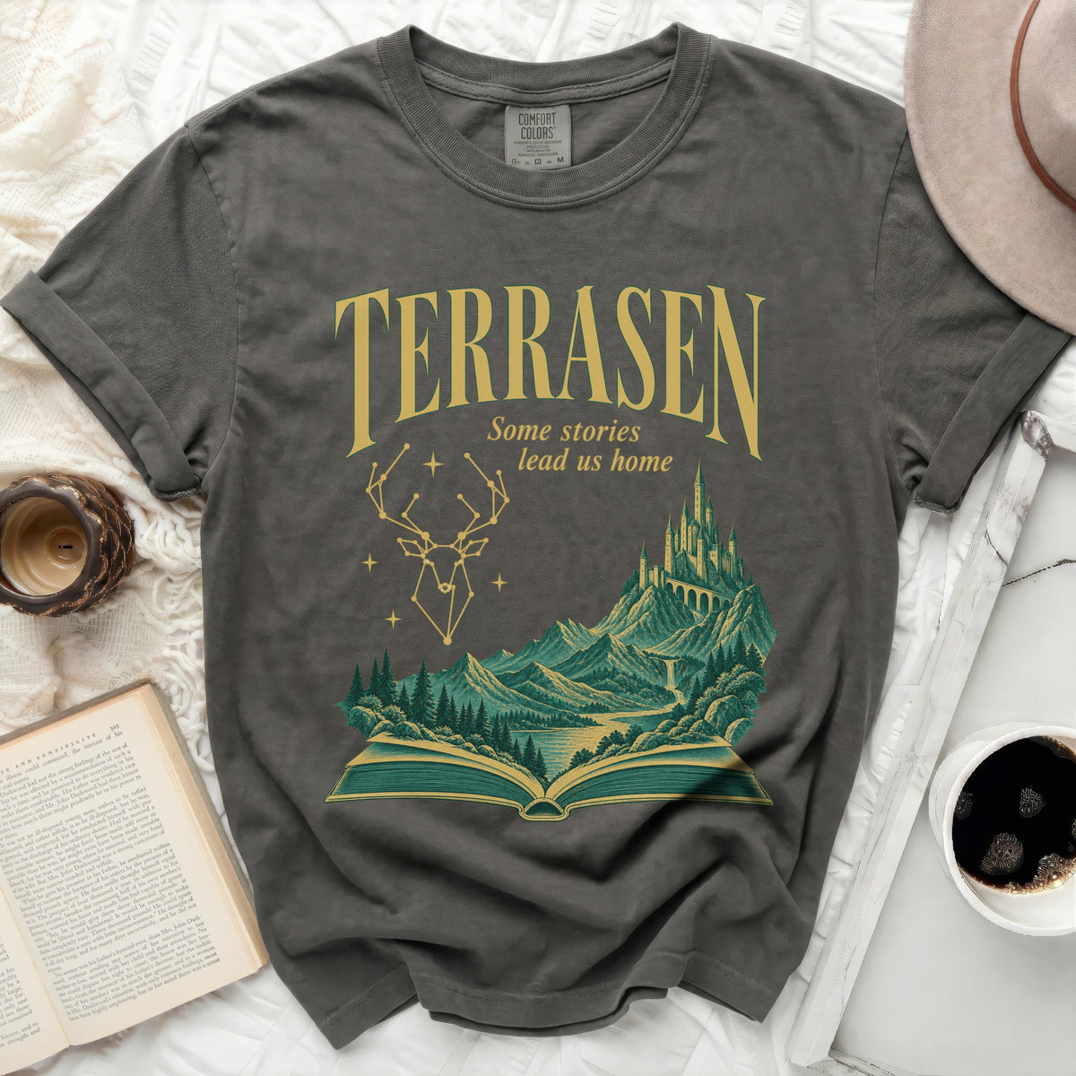 Gray t-shirt with "Terrasen Some stories lead us home" and a fantasy landscape.