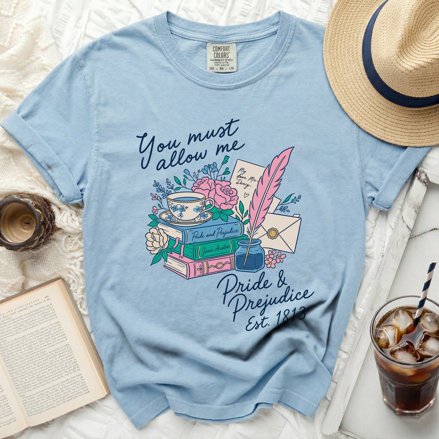 Light blue t-shirt with "Pride & Prejudice Est. 1813" floral graphic.