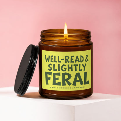 Amber jar candle with lit wick and lid, text reads "Well-Read & Slightly Feral."