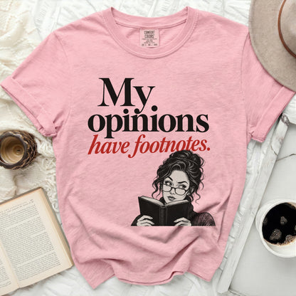 Pink t-shirt with "My opinions have footnotes" text and illustration of a woman reading.