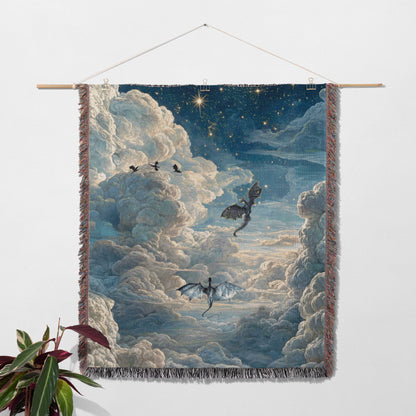 a large tapestry hanging on a wall, featuring a night sky with clouds and stars. The tapestry has a dragon flying in the sky, and there are other dragons and birds in the scene.