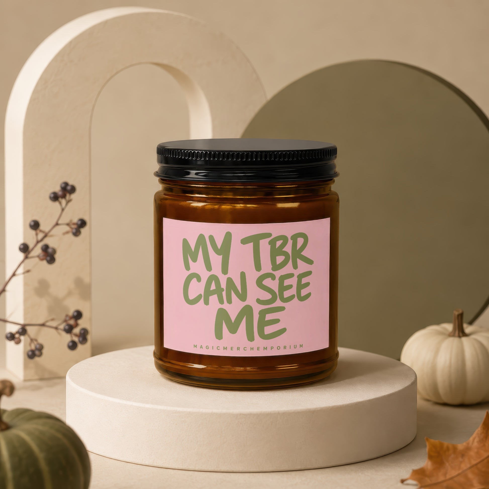 Amber jar candle with black lid and pink label reading "MY TBR CAN SEE ME".
