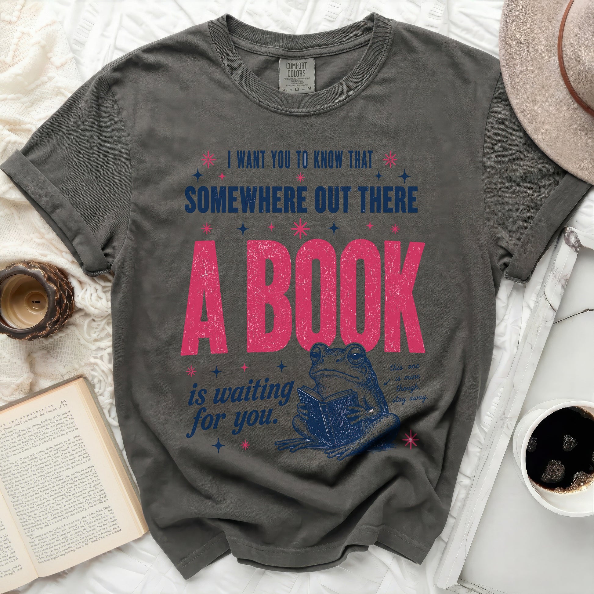 Dark grey t-shirt with frog reading book and inspirational text.