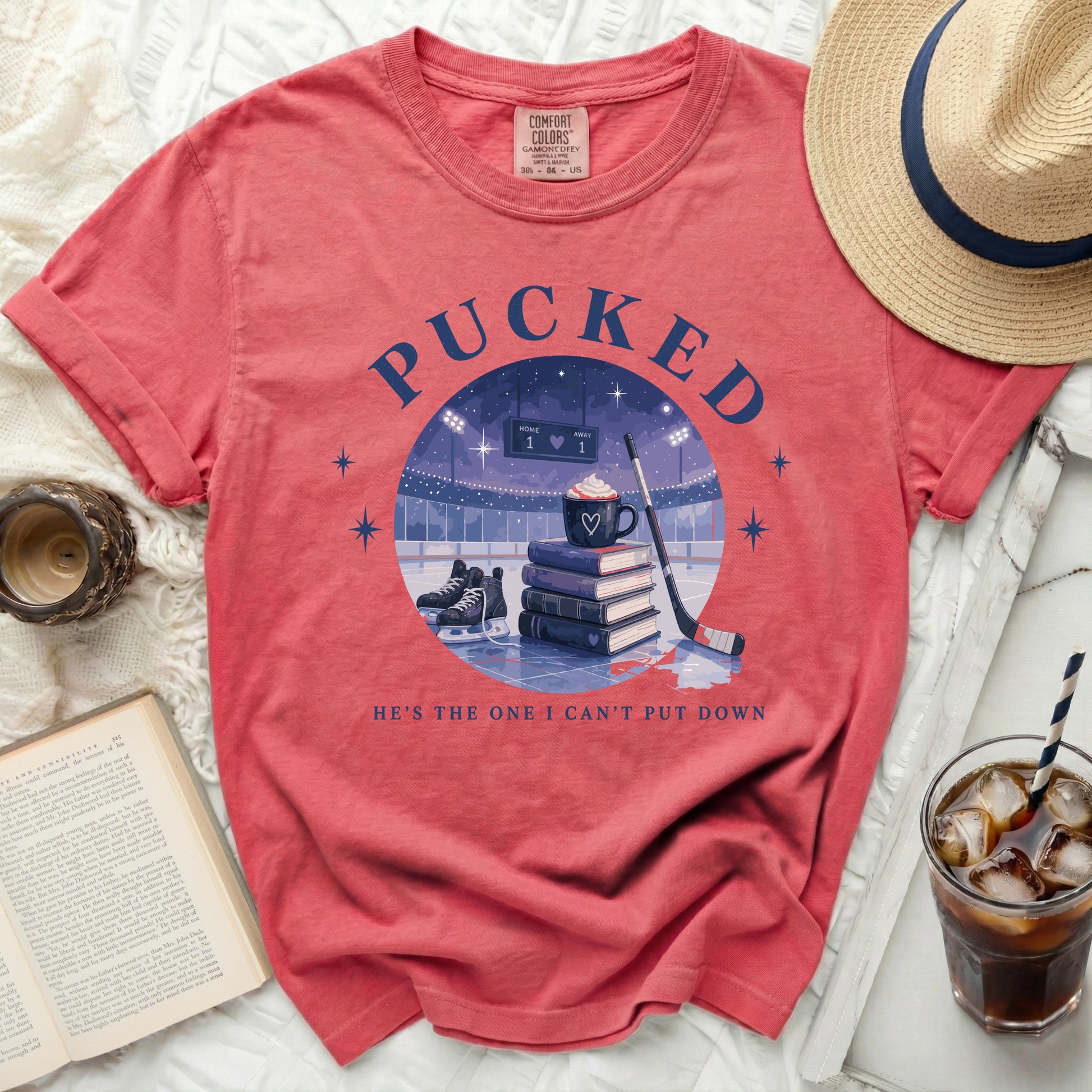 T-shirt with "Pucked" and ice hockey rink graphic, "He's the one I can't put down" text.