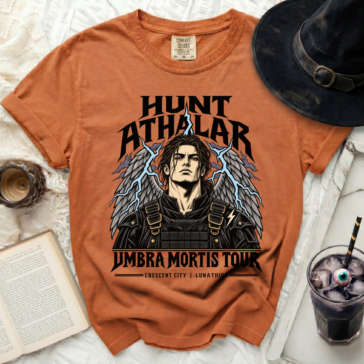Orange t-shirt with "HUNT ATHALAR UMBRA MORTIS TOUR" text and winged character art.
