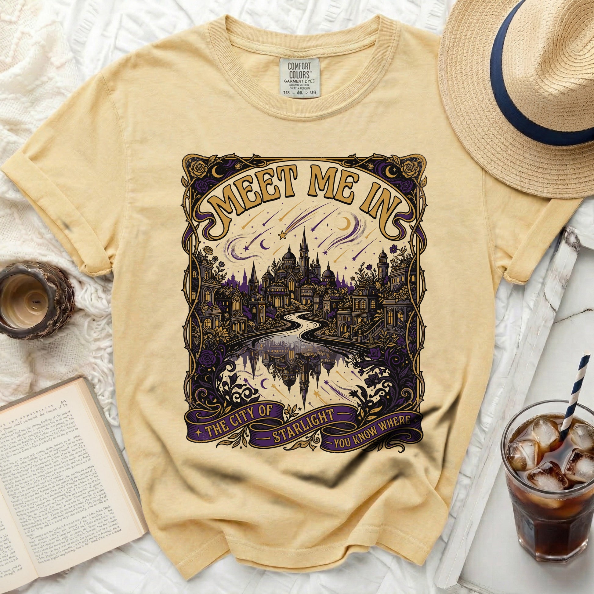 Light yellow Comfort Colors t-shirt with "Meet Me In The City of Starlight" graphic.