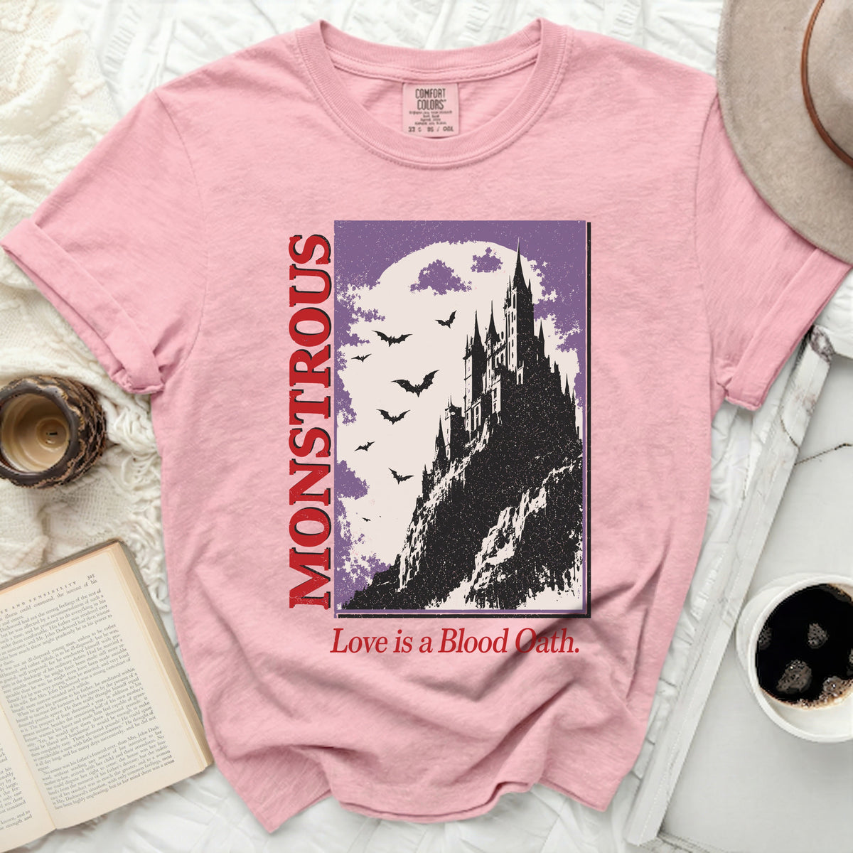 Pink t-shirt with "Monstrous Love is a Blood Oath" gothic castle design.