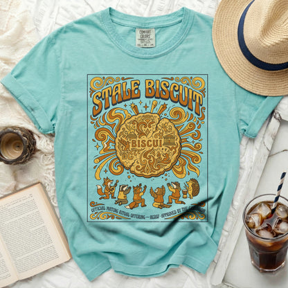Aqua t-shirt with "Stale Biscuit" graphic featuring anthropomorphic animals and a biscuit.