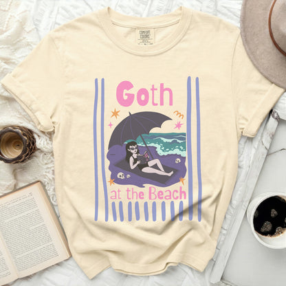 Cream t-shirt with "Goth at the Beach" graphic of a vampire and umbrella.