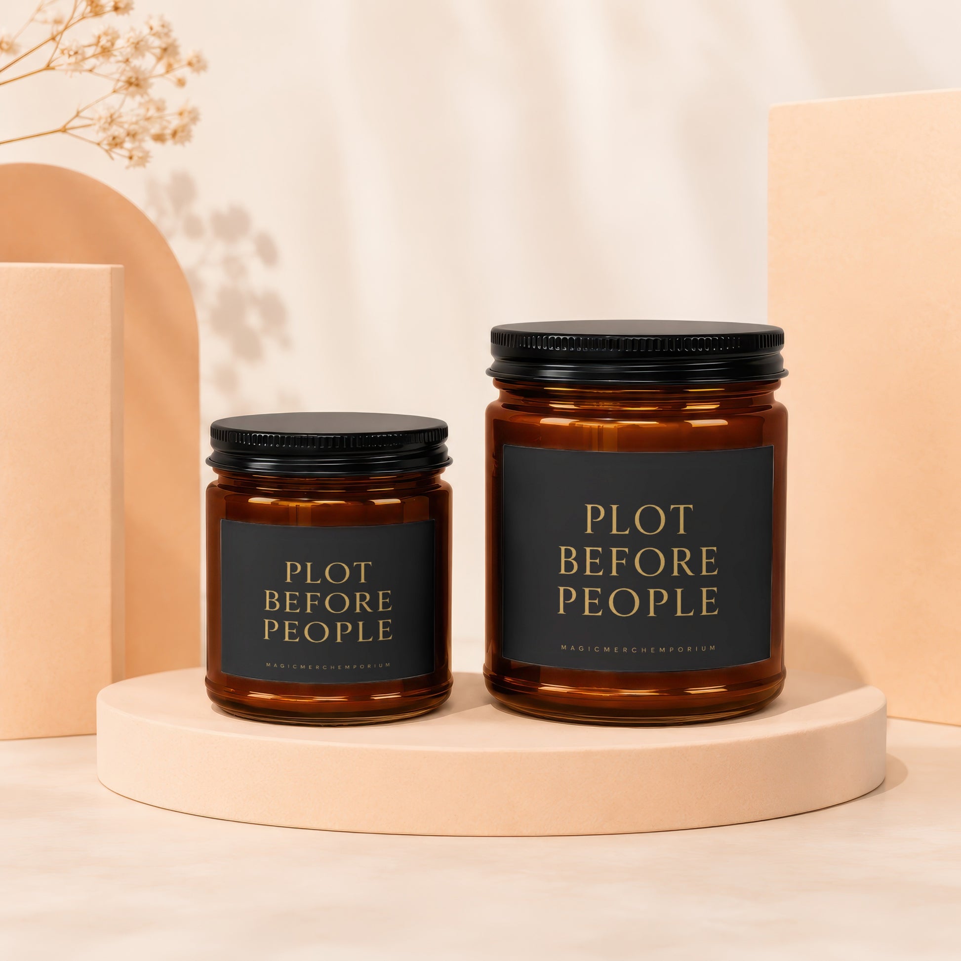 Two amber glass candles with black lids and dark labels reading "PLOT BEFORE PEOPLE".