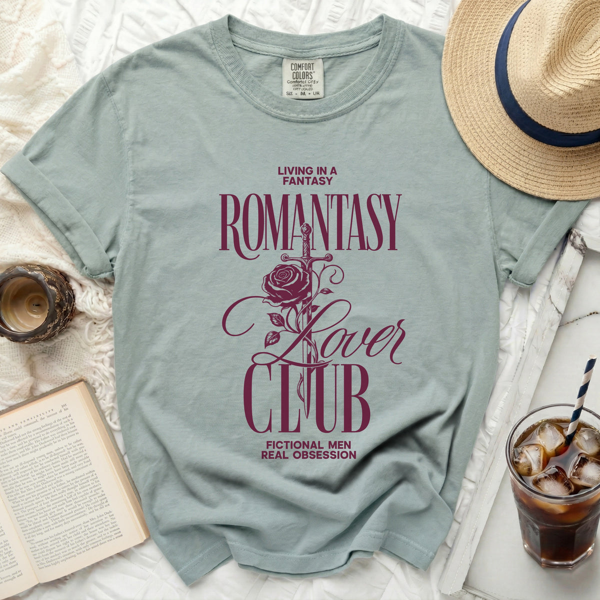 Comfort Colors light blue t-shirt with "Romantasy Lover Club" graphic and text.
