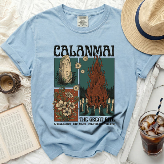 Light blue t-shirt with "CALANMAI THE GREAT RITE" graphic.