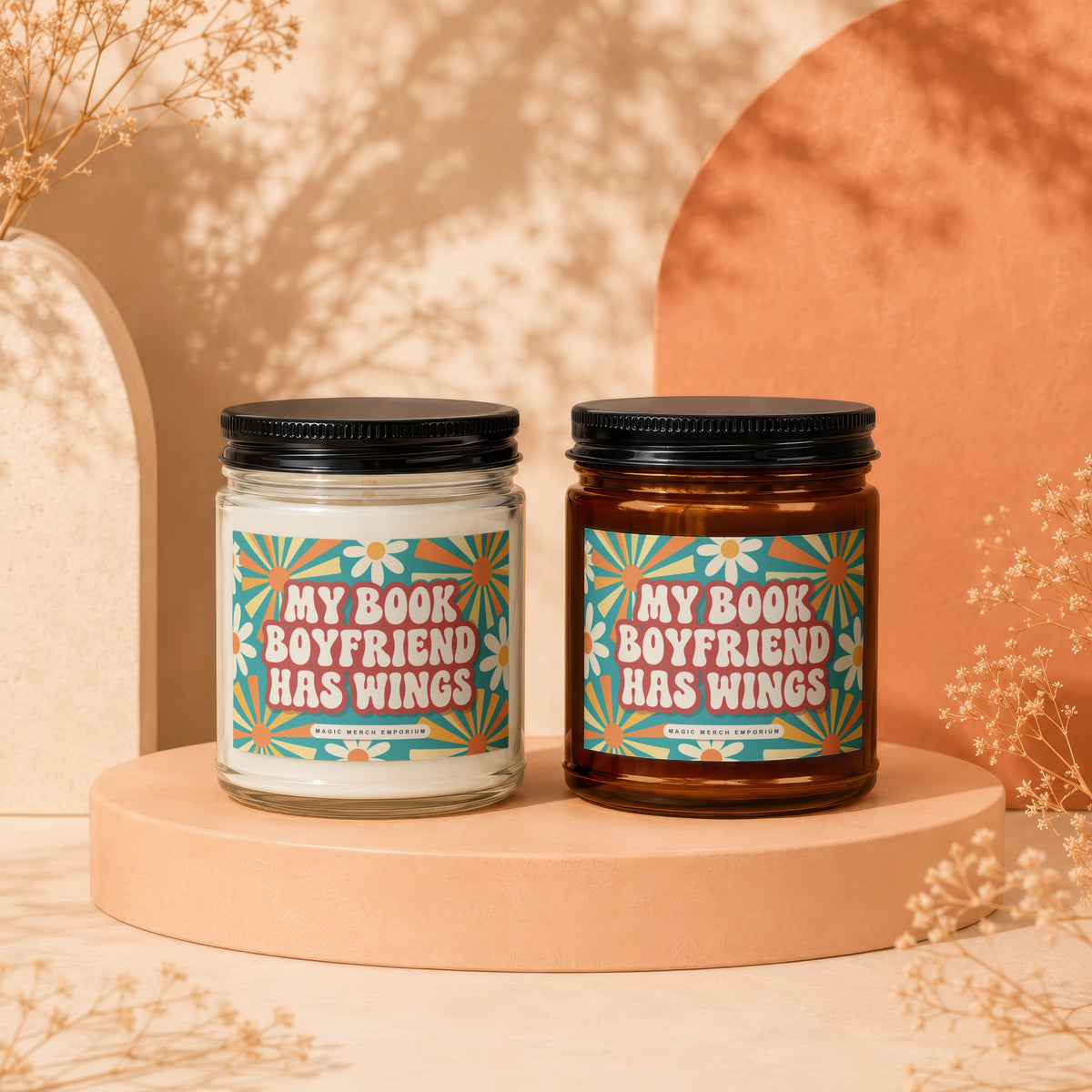 Two candles with "MY BOOK BOYFRIEND HAS WINGS" labels and floral designs.