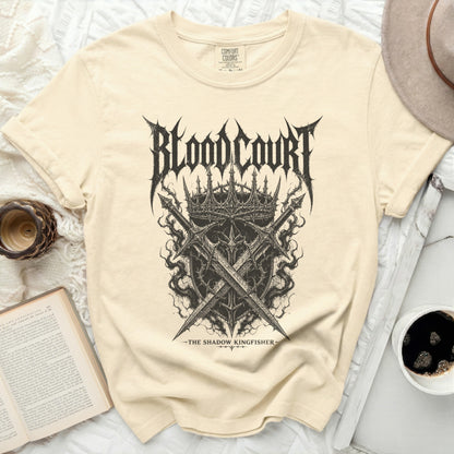 Cream t-shirt with "Blood Court The Shadow Kingfisher" band logo.