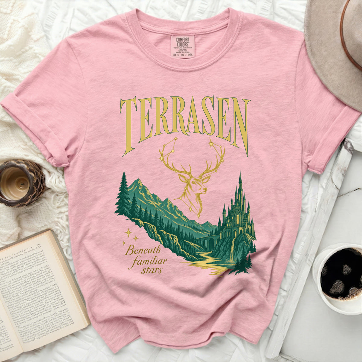 Pink t-shirt with "TERRASEN" and "Beneath familiar stars" text and graphic.