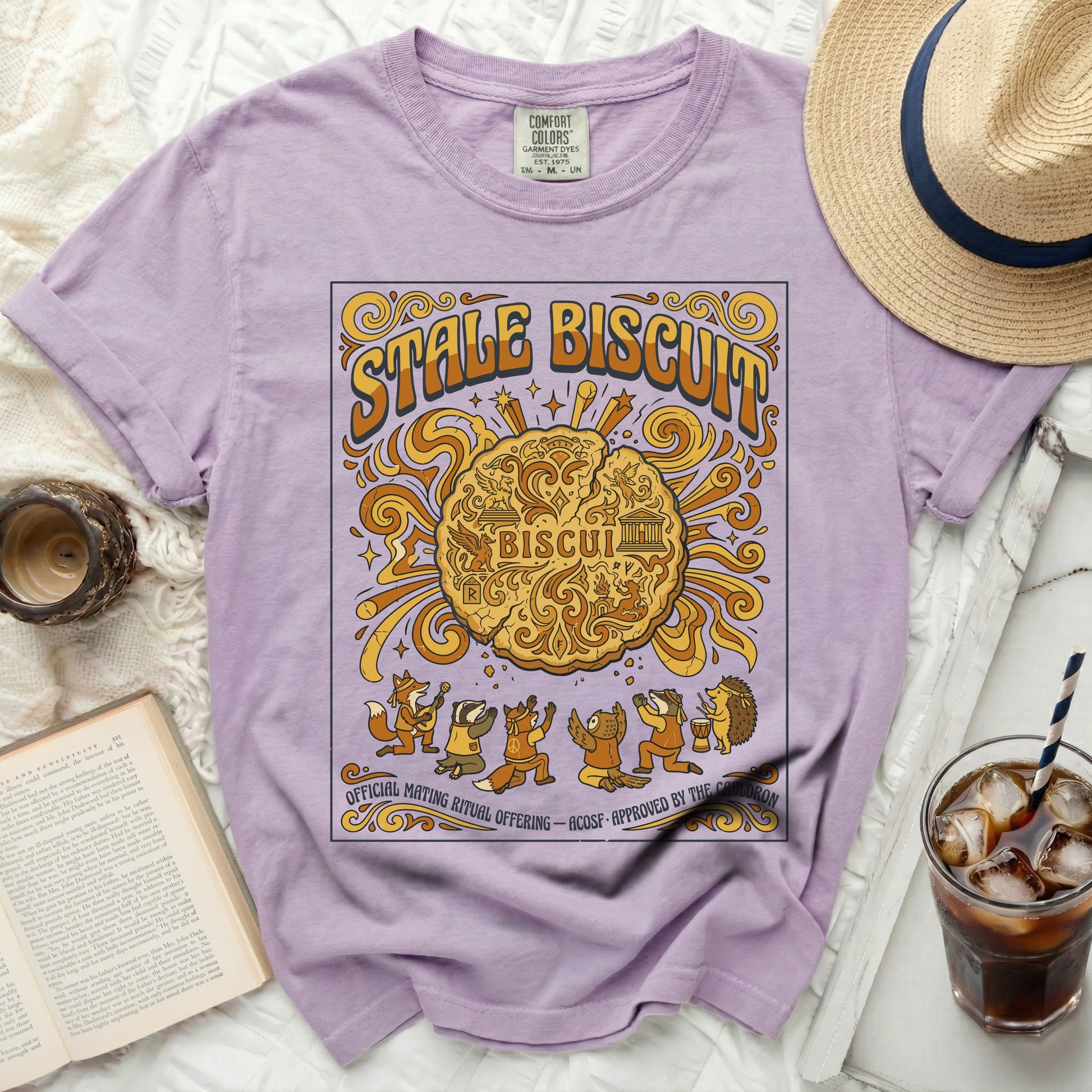 Lavender t-shirt with "Stale Biscuit Official Mating Ritual Offering" graphic.