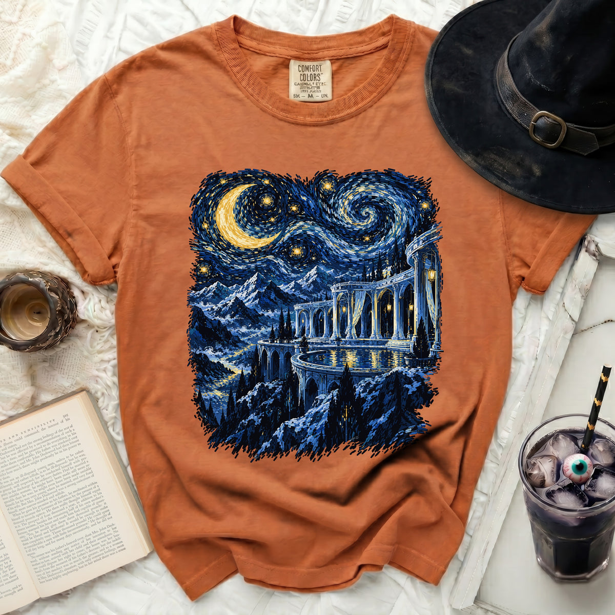 Orange t-shirt with a starry night landscape and a palace graphic.