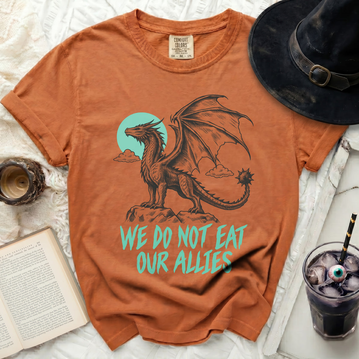 Orange t-shirt with dragon graphic and text "WE DO NOT EAT OUR ALLIES".