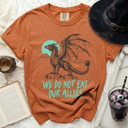 Orange t-shirt with dragon graphic and text "WE DO NOT EAT OUR ALLIES".