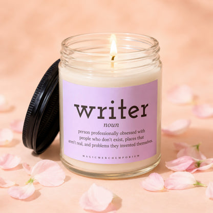 Lit candle in glass jar with "writer" definition label and pink petals.
