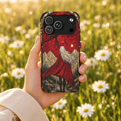 A hand holds a smartphone featuring a stained-glass style fantasy case against a blurred daisy field backdrop.