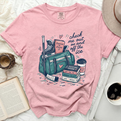 Pink t-shirt with "check me out on and off the ice" graphic.