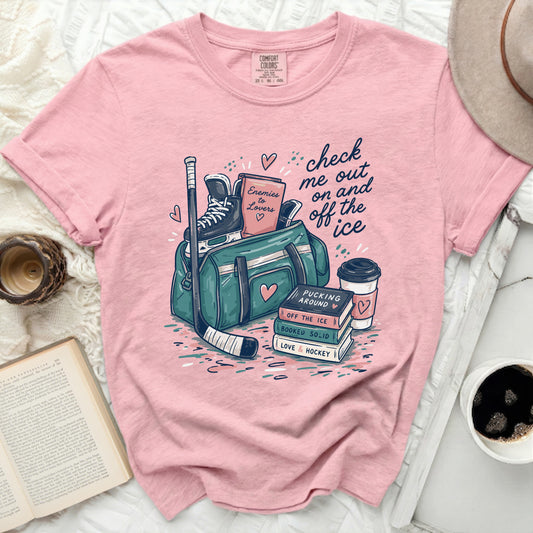 Pink t-shirt with "check me out on and off the ice" graphic.