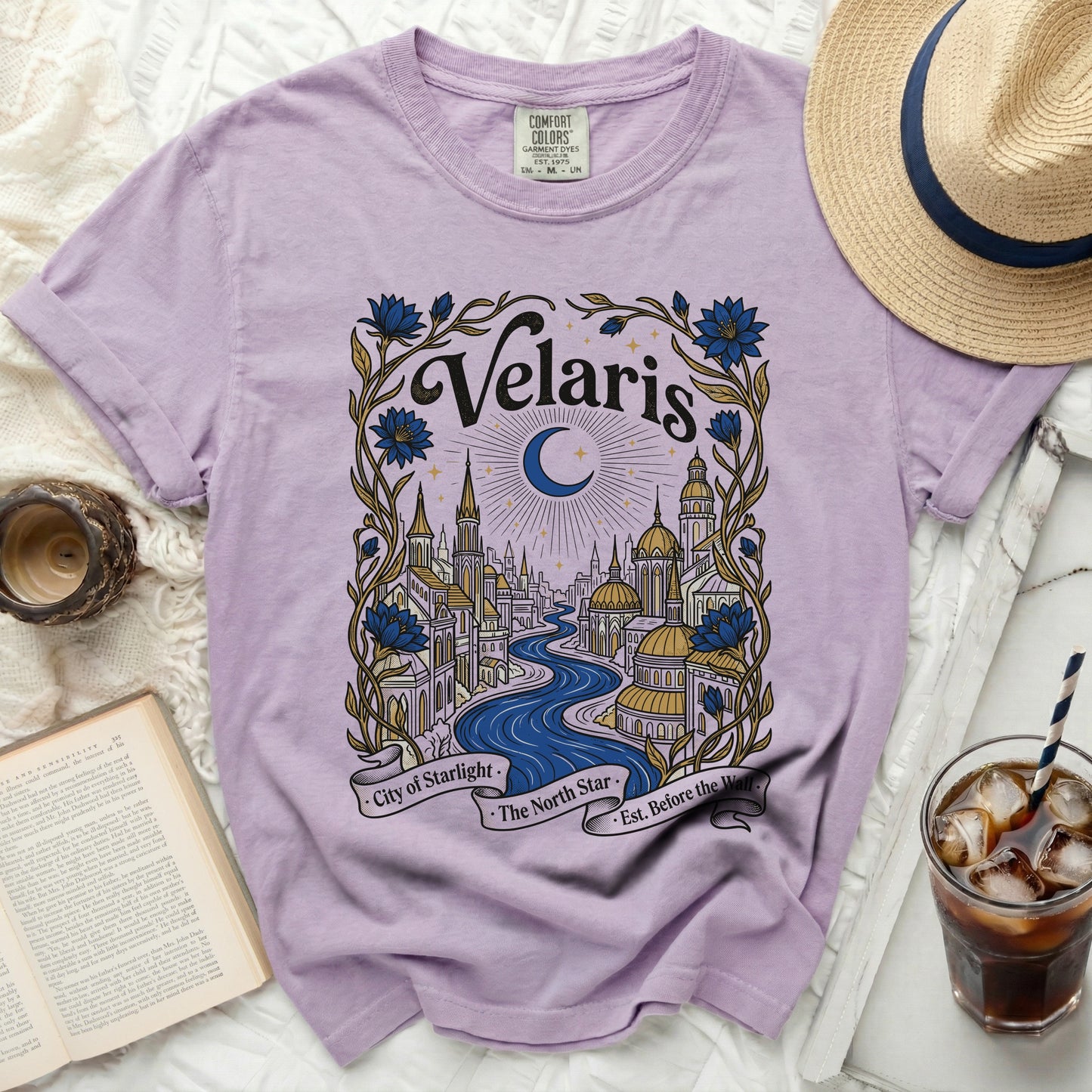 Lavender t-shirt with a "Velaris" graphic featuring a cityscape and moon.