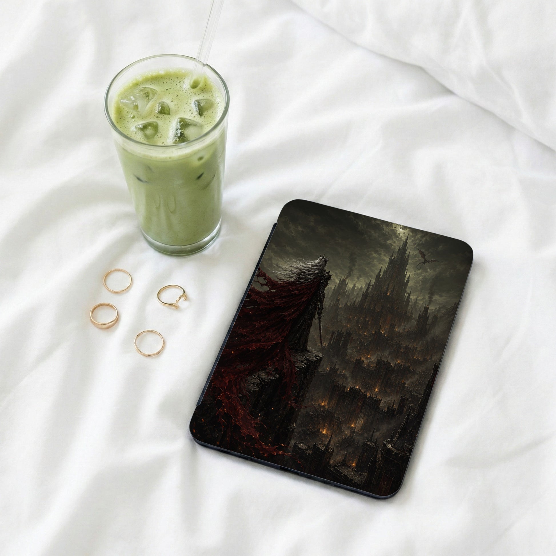 Tablet with dark fantasy art of a figure overlooking a fiery, gothic cityscape.
