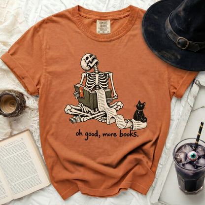 Skeleton reading long scroll from book with black cat and text "oh good, more books."