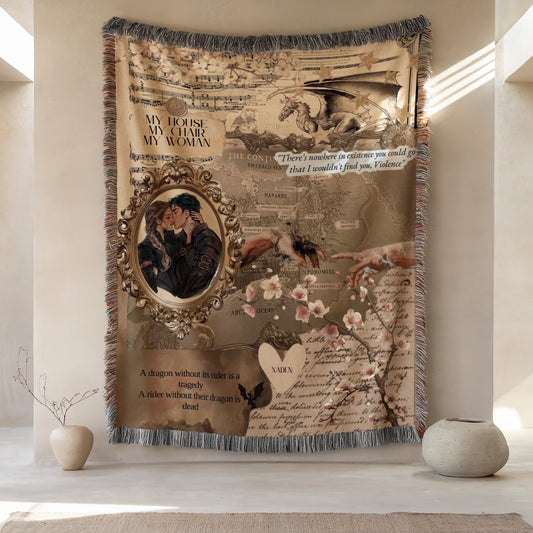a large tapestry hanging on a wall, with various decorative elements such as a dragon, flowers, and a couple embracing. The tapestry also includes text and imagery related to the story of "A dragon without its rider is a tragedy. A rider without their dragon is dead."