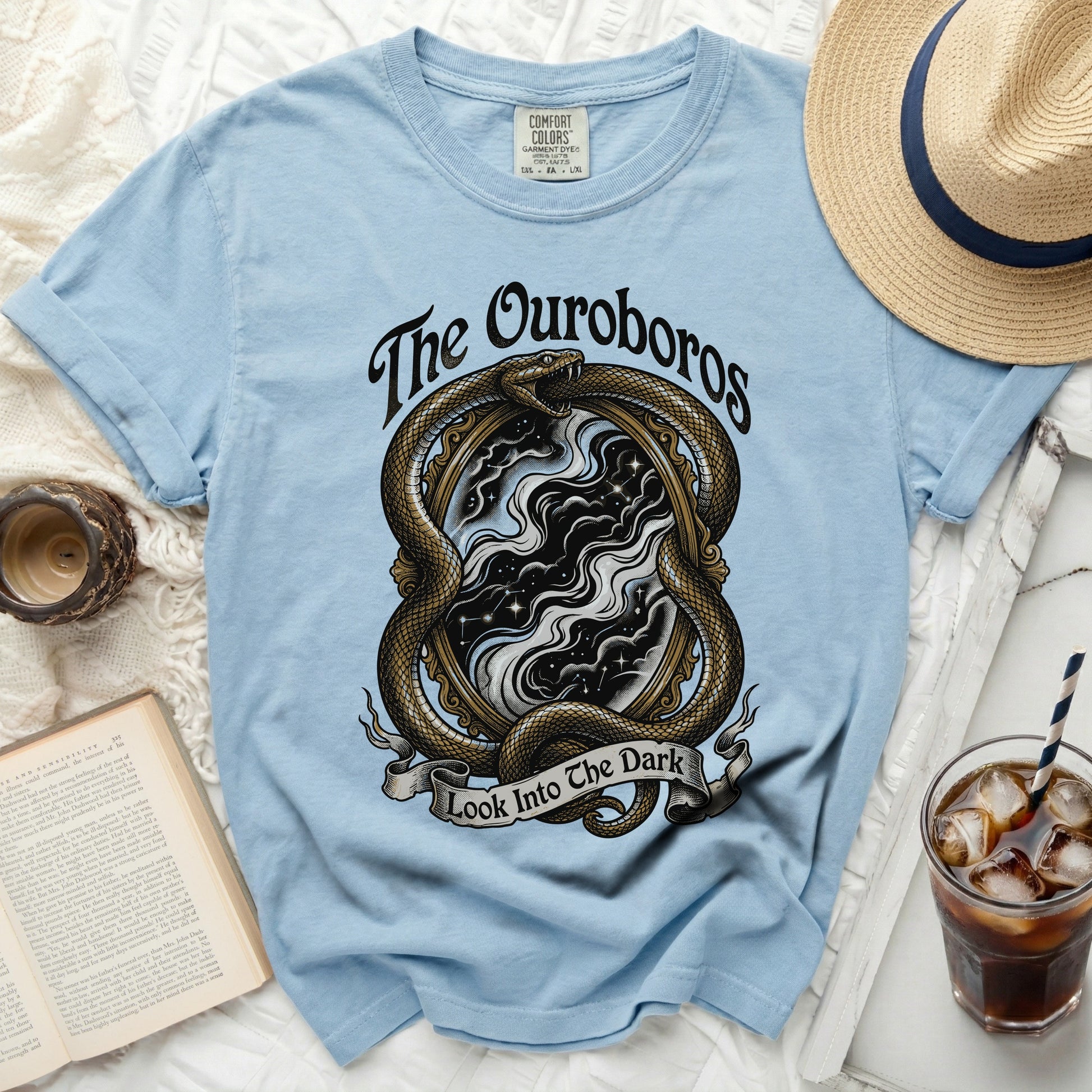 Light blue t-shirt with Ouroboros snake and "The Ouroboros Look Into The Dark" text.