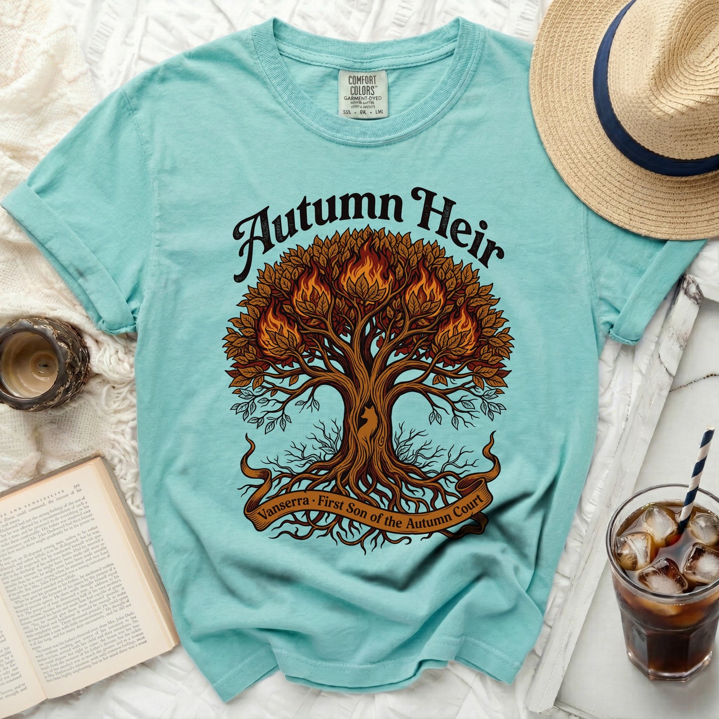 Turquoise t-shirt with a fiery tree graphic and text "Autumn Heir".