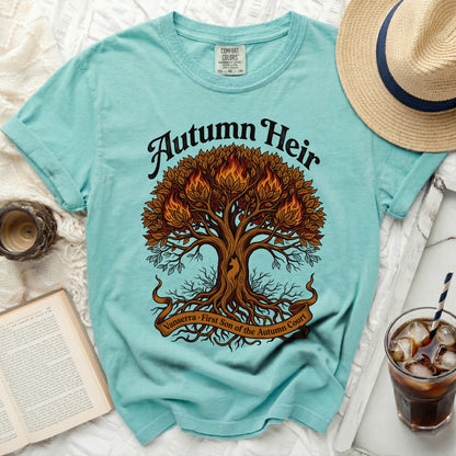 Turquoise t-shirt with a fiery tree graphic and text "Autumn Heir".