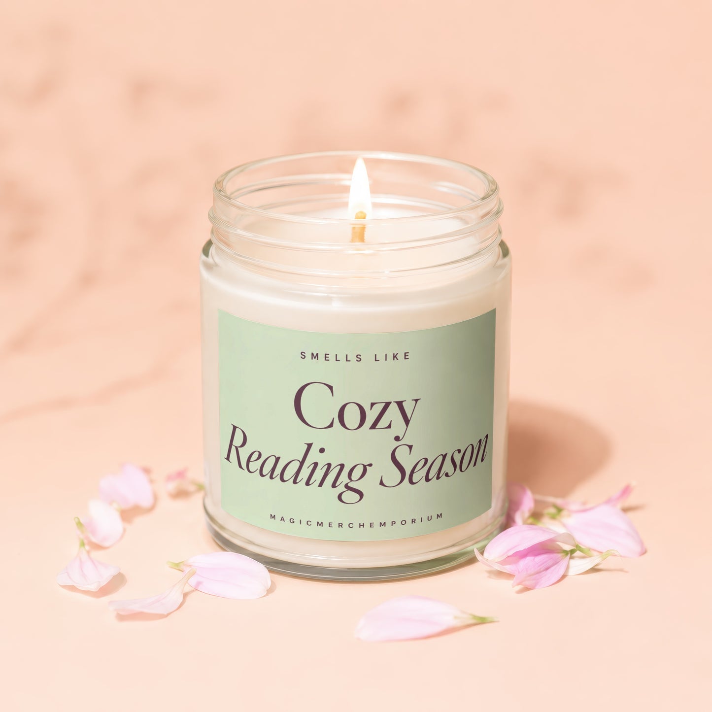 Lit candle with "Cozy Reading Season" text on a light green label.