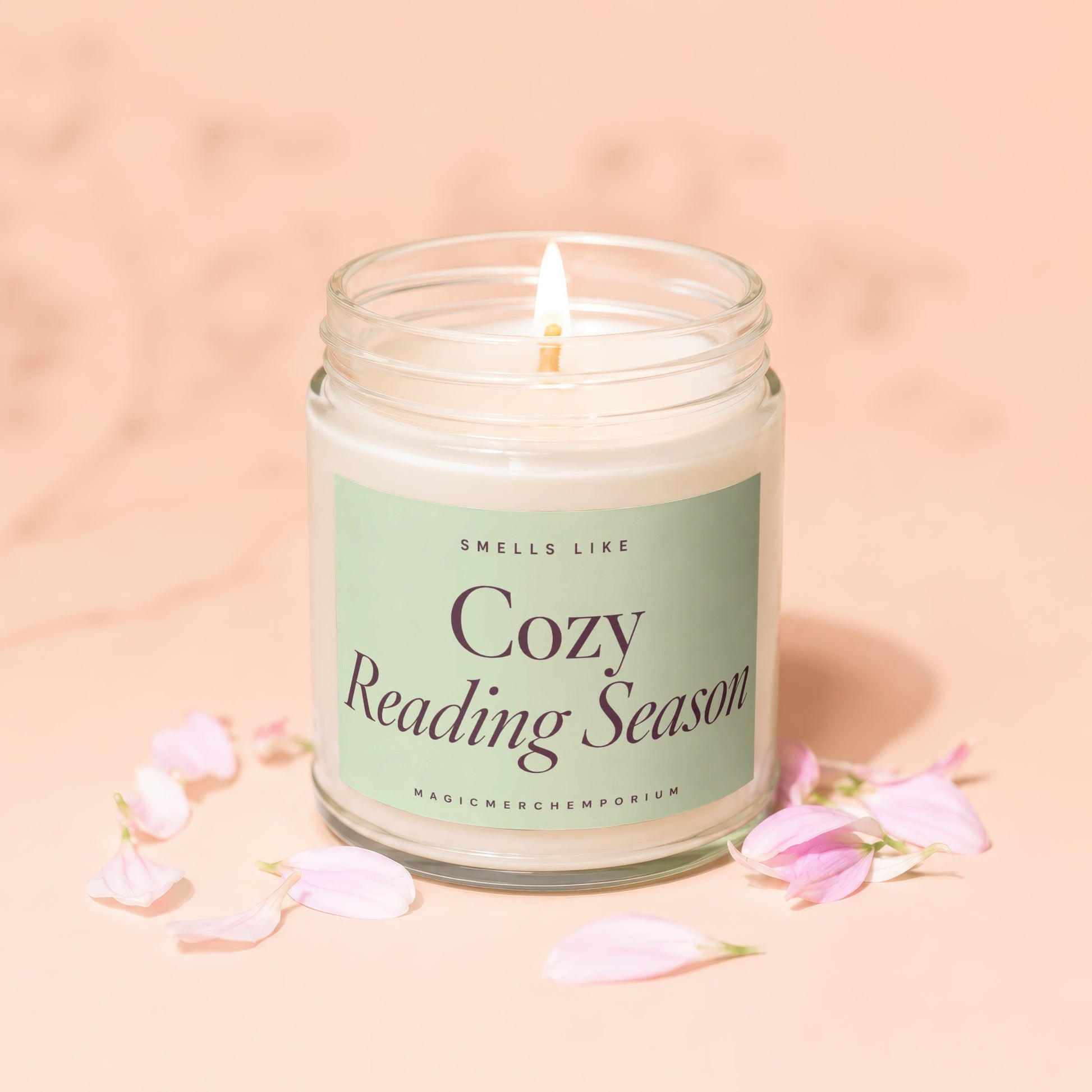 Lit candle with "Cozy Reading Season" text on a light green label.