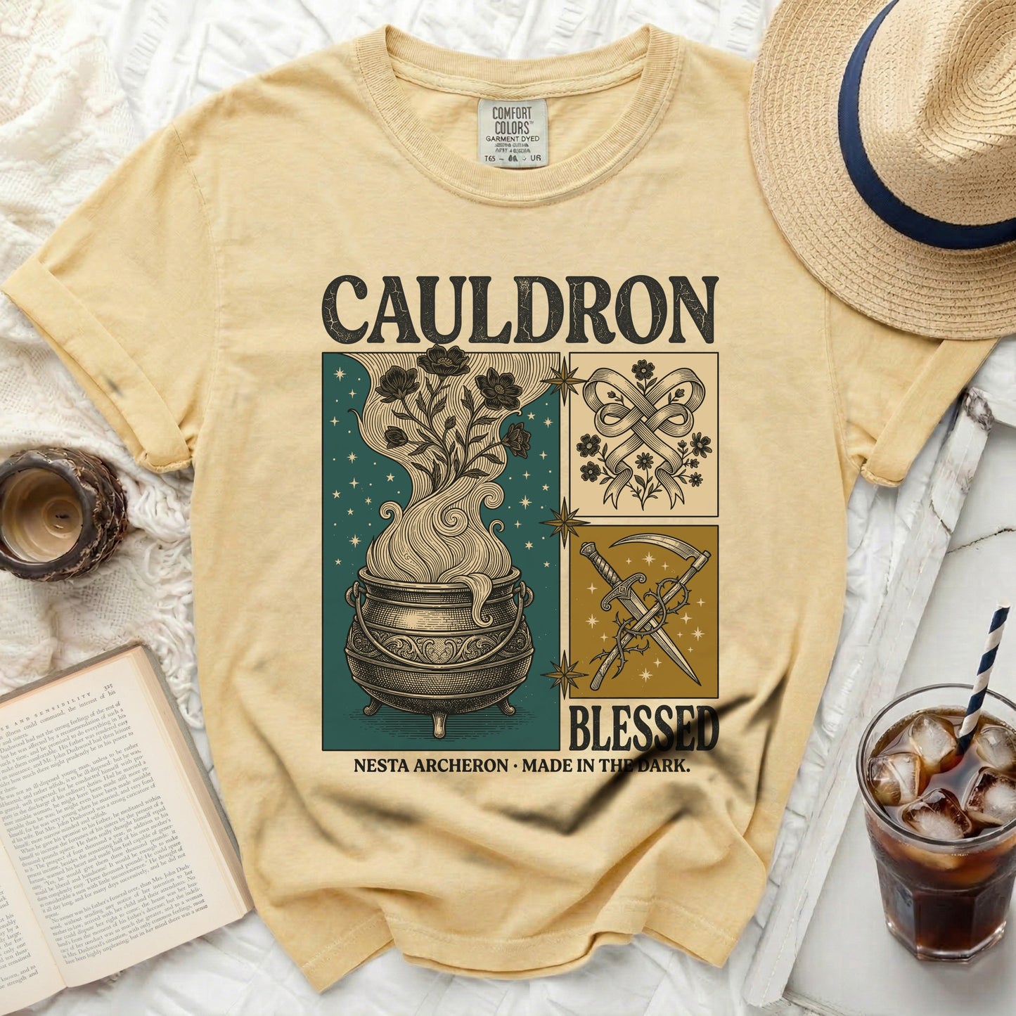 Yellow t-shirt with "CAULDRON BLESSED NESTA ARCHERON MADE IN THE DARK" graphic.