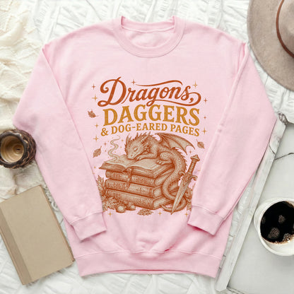 Pink sweatshirt with "Dragons, Daggers & Dog-Eared Pages" and dragon graphic.
