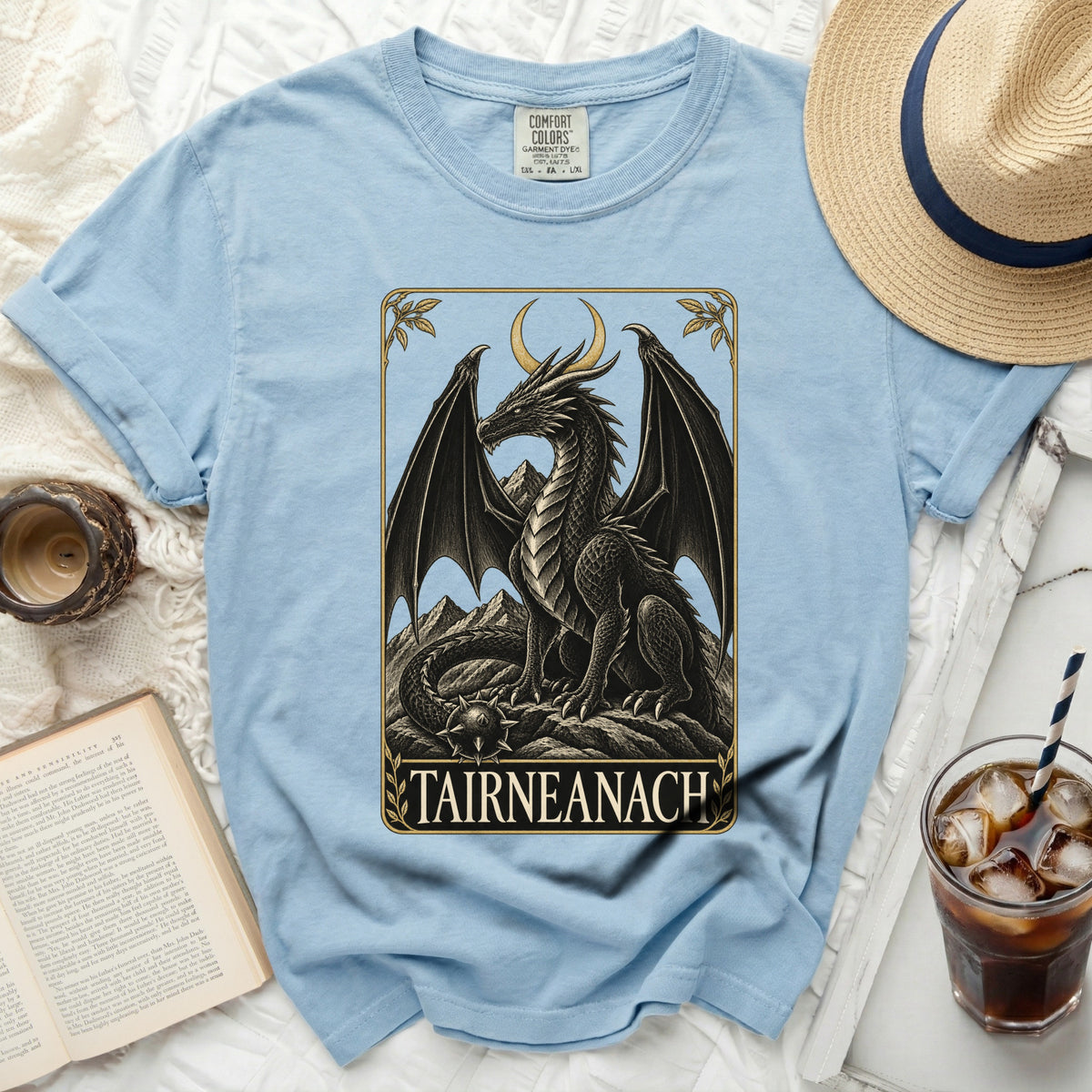 Light blue t-shirt with a black dragon design and "TAIRNEANACH" text.